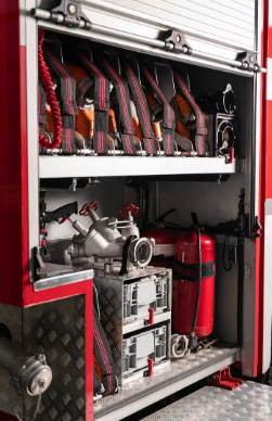 Fire truck equipment compartment with hoses, tools, and fire extinguishers neatly stored
