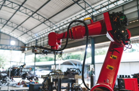 Industrial robotic arm used for automated manufacturing processes inside a factory facility